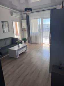a living room with a couch and a coffee table at Cozy Crib 2 in Mamaia Sat/Năvodari