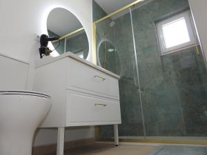 a bathroom with a toilet and a sink and a shower at Casa Rural Isabel y Luis in Chiloeches +30 photos