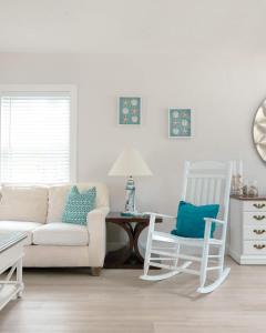 a living room with a couch and two chairs at Poolside Palms - Team Joseph Ellen in Jacksonville Beach