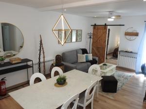 a living room with a table and a couch at Casa Rural Isabel y Luis in Chiloeches