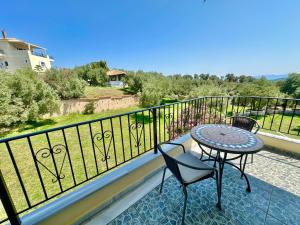 a patio with a table and chairs on a balcony at Villa in Skiathos in Skiathos
