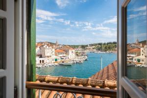 a view from a window of a harbor with boats at Palazzo Viridis Heritage Hotel in Milna
