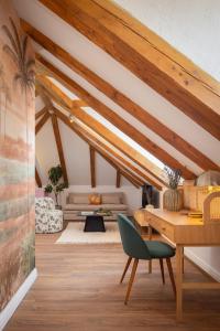 a living room with wooden ceilings and a green chair at Palazzo Viridis Heritage Hotel in Milna +66 photos