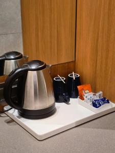 a tea kettle is sitting on a counter at Krishna Palace Hotel , Ulhasnagar in Ulhāsnagar