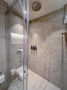a bathroom with a shower and a sink at Krishna Palace Hotel , Ulhasnagar in Ulhāsnagar