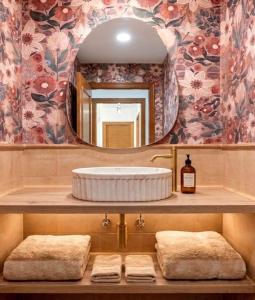 a bathroom with a sink with a mirror and towels at Marbella Views in Ojén