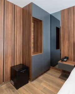 ein Zimmer mit holzgetäfelten Wänden und einem Schreibtisch in der Unterkunft SOLO Hotel in Prizren