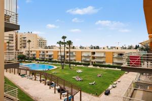 a view of a courtyard with a pool in a building at Brisa Do Mar Moura Beach in Quarteira