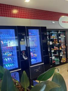 two vending machines in a store with drinks in them at Seu espaço in Sorocaba