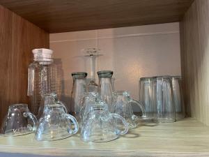 a shelf filled with glass jars and bottles at Seu espaço in Sorocaba