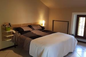 a bedroom with a large white bed in a room at Ca di Biella, mansarda di charme. in Biella