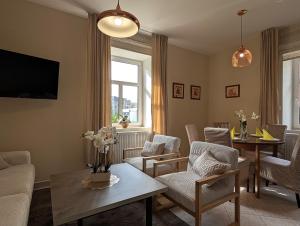 a living room with a couch and chairs and a table at Apartmány penzion Jasmín in Liberec