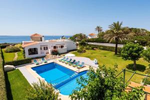 an aerial view of a villa with a swimming pool at Villa Mercedes by Villa Plus in Cala en Forcat