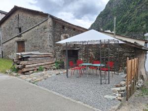 a table and chairs in front of a building at Casa Piazzo Due in Brusio