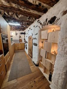 a large kitchen with wooden cabinets and a door at Casa Piazzo Due in Brusio +21 photos