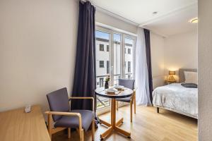 a room with a bed and a table and chairs at Apartments Lübeck in Lübeck