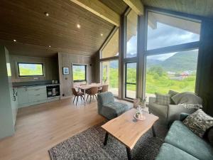 a living room with a couch and a table at Lofoten Arctic Cabin in Sørvågen