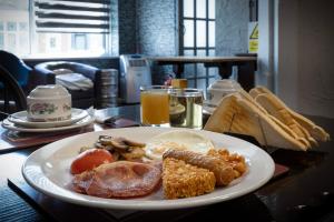 a plate of breakfast food on a table at 100 Pipers Hotel in Blackpool +27 photos