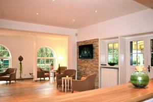 a living room with chairs and a fireplace at Landhaus Gut Halte in Papenburg