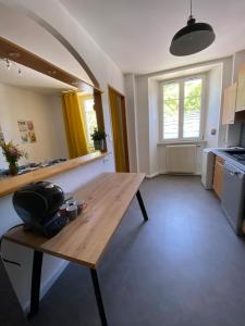 a room with a wooden table in a kitchen at Le Grand 27 in Guebwiller +45 photos