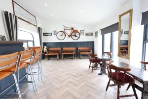 a dining room with a bike hanging on the wall at Harbour View - Sleeps 26 guests in Liscannor