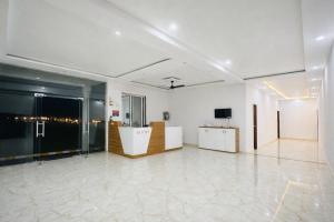 a large room with white walls and a white floor at Kanha Green in Habībganj