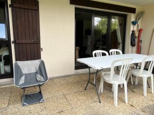 a white table and chairs in front of a house at LE GL'ASSIE in Saint-Gervais-les-Bains +8 photos