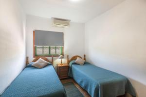 a room with two beds and a window at Apartamento B Armonia Rural in Granadilla de Abona +18 photos