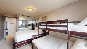 a room with four bunk beds in it at Snow Ghost Inn 220 by Okanagan Premier in Big White
