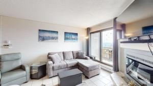 a living room with a couch and a fireplace at Snow Ghost Inn 220 by Okanagan Premier in Big White
