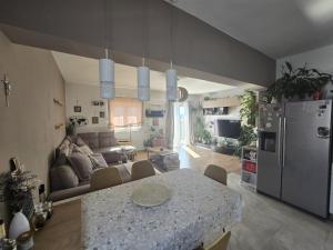 a kitchen and living room with a table and a refrigerator at Villa Joy- Paradise near Split by Istra Vacation in Kučine