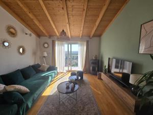 a living room with a green couch and a tv at Villa Joy- Paradise near Split by Istra Vacation in Kučine
