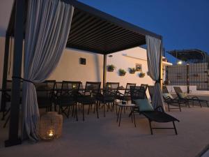 a group of chairs and tables on a patio at night at Villa Joy- Paradise near Split by Istra Vacation in Kučine