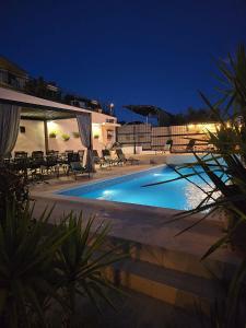 a swimming pool at night with chairs and tables at Villa Joy- Paradise near Split by Istra Vacation in Kučine +46 photos