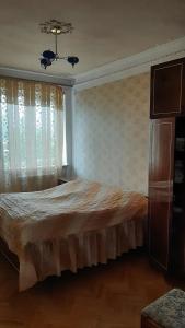 a bedroom with a bed and a window with curtains at Saraharth in Alaverdi