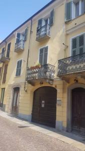 a building with two doors and two balconies on it at Casa della Ludo Biella in Biella