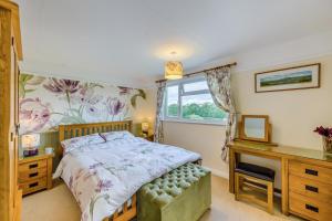 a bedroom with a bed and a desk and a window at 3 Bed in Brecon oc-bn363 in Brecon