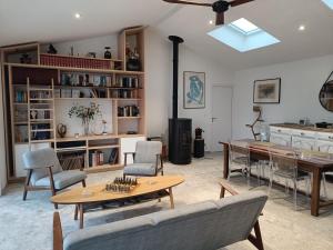 a living room with a table and chairs at La Barjuline - Île d'Oléron in La Brée-les-Bains