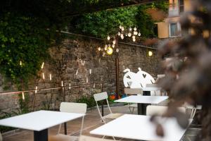 a group of tables and chairs in a restaurant at Le Funi Hotel in Bergamo