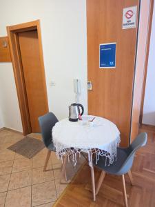 a table with a tea kettle on it in a room at Laki Apartment in Podgorica +6 photos