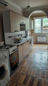 a kitchen with white cabinets and a stove top oven at Saraharth in Alaverdi