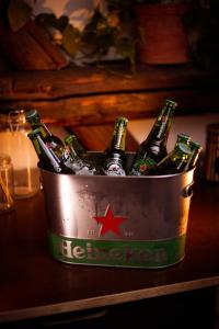 a bucket filled with bottles of beer sitting on a table at Das Nest Budapest in Budapest