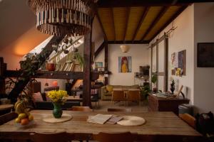 a living room with a wooden table in a room at Das Nest Budapest in Budapest