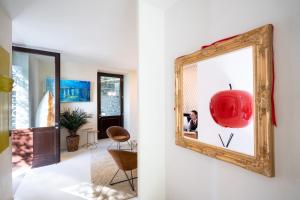 a mirror hanging on a wall next to a living room at Le Funi Hotel in Bergamo +62 photos
