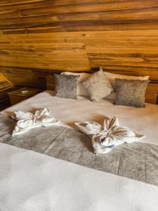a large bed with two pillows on it at Cabaña Kokkos Del Mar in Santa Marta