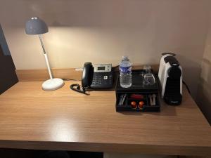 a desk with a phone on top of a table at La Tour Des Lys in Maubeuge