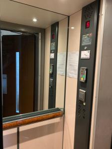 a elevator in a train with a mirror at Chambre à Montmartre in Paris
