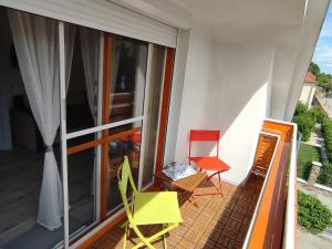 a balcony with a table and two chairs on a balcony at Nyárfa Vendégház in Balatonmáriafürdő