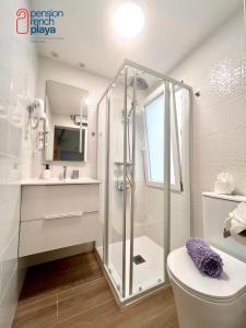 a bathroom with a shower and a toilet and a sink at Pensión RENCH in Alcossebre