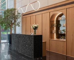 a lobby with a counter with flowers in it at Azamra in Uman